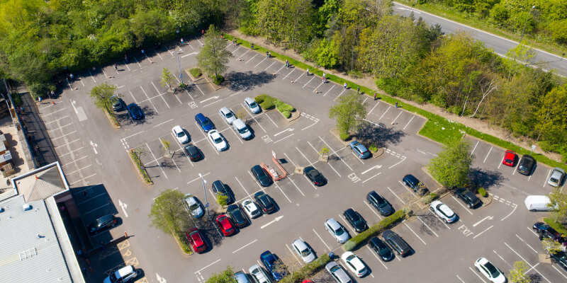 Aerial view of car park with cars parked in bays