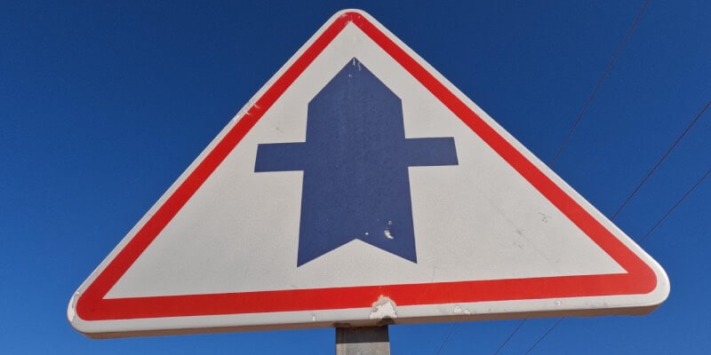 Triangle sign with crossroad marking displayed