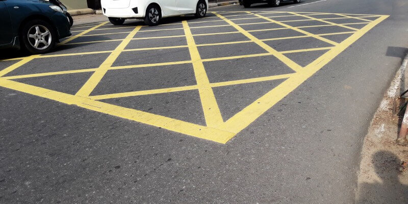 Yellow box on the road with cars stopped on it